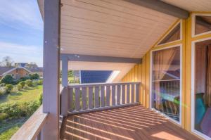 eine Veranda eines Hauses mit Balkon in der Unterkunft Seeschwalbe Classic 58 in Rechlin