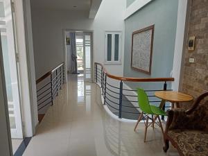 a hallway of a house with a table and chairs at Rose's House Hue in Hue