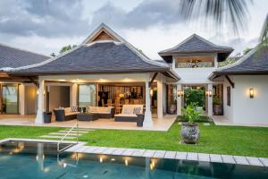 a house with a pool in front of it at Miskawaan Luxury Beachfront Villas in Mae Nam