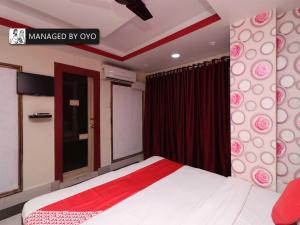 a bedroom with a bed and a sign that readsmanaged by ox at OYO Ruby Park Trivedi International Near Acropolis Mall in Kolkata