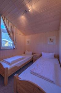 a room with two beds and a window at Seeschwalbe 69A in Rechlin
