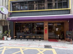 a purple storefront with benches in front of a building at Backpackers Hostel - Ximen in Taipei