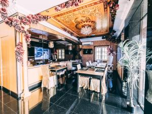 a restaurant with tables and chairs in a room at Seriental Hotel I check in 3pm-11pm only in Tanjong Tokong