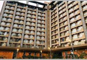 a large apartment building with balconies on it at VHHS studio apartment ,surat airport in Surat