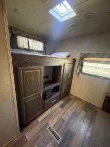 an interior of an rv with a kitchen and a window at Camper Rv1 with private entrance and free parking in Moreno Valley