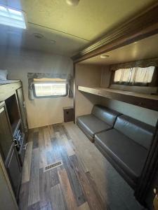 an interior view of an rv with a couch and window at Camper Rv1 with private entrance and free parking in Moreno Valley