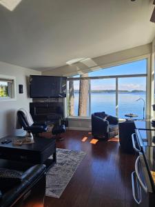 a living room with a view of the water at Sunrise Terraces in Ladysmith