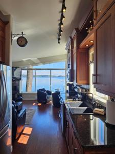 a kitchen with a large view of the ocean at Sunrise Terraces in Ladysmith