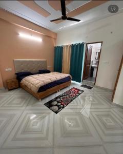 a bedroom with a bed and a ceiling fan at Anvi Home Stay in Rishīkesh