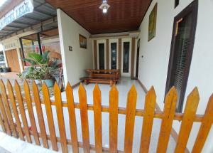 una recinzione di legno di fronte a una casa di Vallery homestay a Geruntang