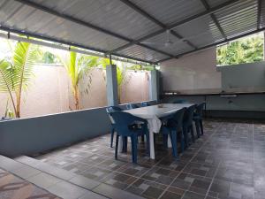 a dining room with a table and chairs on a patio at Villa Elyza in Rodrigues Island