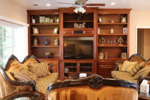 a living room with a couch and a tv at Home with Infinity Pool and Mountain View in El Cajon