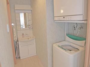 a bathroom with a washing machine and a sink at Churaumi Terrace in Motobu +30 photos