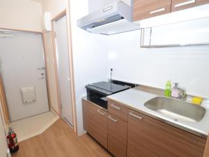 a kitchen with a sink and a counter top at Churaumi Terrace in Motobu