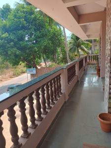 a balcony of a house with trees in the background at Ashirwad Residency in Agonda