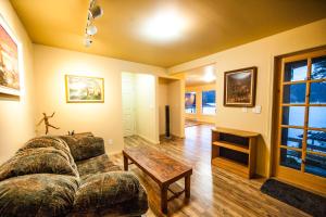 a living room with a couch and a table at shangrila waterfront vacation home in Pender Island