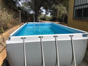 a large white tub with a blue swimming pool at Los Pinos in Alginet