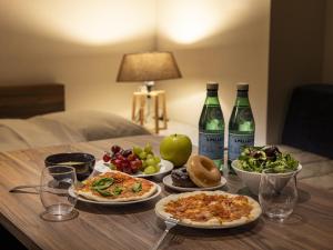 a table with plates of food and bottles of wine at Tokyu Stay Nishi Shinjuku in Tokyo