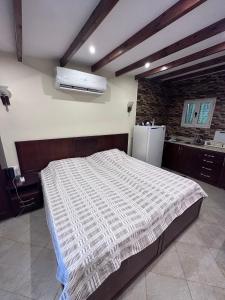 a bedroom with a large bed and a refrigerator at Studio 2 in Sharm El Sheikh