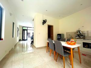 a kitchen and dining room with a table and chairs at Homestay CX 8 -129 in Hòa Bình