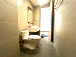 a bathroom with a toilet and a sink at Homestay CX 8 -129 in Hòa Bình +29 photos