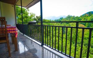 a balcony with a view of a lush green field at Ella RV Heaven World Hotel in Ella