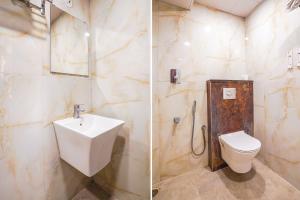 a bathroom with a toilet and a sink at FabHotel Prime Signature Inn in Bangalore