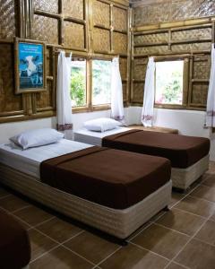 Postelja oz. postelje v sobi nastanitve Bamboo Sanctuary Pancawati