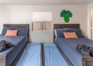 um quarto com 2 camas com lençóis azuis e uma janela em Pool Spa Fire Pit Pets Ensuite Bathrooms em Lake Havasu City