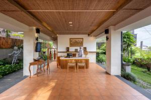 an open living room with a table and chairs at Dedary Resort & Spa Ubud by Ini Vie Hospitality in Ubud