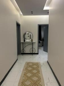 a hallway with a table and a mirror on the wall at سويت في حي مشرفه في شارع فلسطين in Jeddah