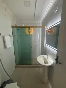 a bathroom with a glass shower and a sink at Pousada Oceanic in Arraial do Cabo