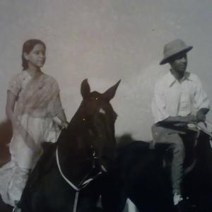 a man and a woman standing next to a horse at College House Close to Fort in Colombo