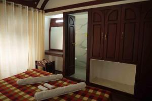 a bedroom with a bed and a mirror and a shower at Aqua Castle Houseboat - by Aqua Jumbo Houseboats in Alleppey