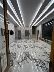 a large room with a marble floor and a hallway at سويت في حي مشرفه في شارع فلسطين in Jeddah