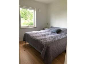 a bedroom with a bed and a window at House Sjötorp Comfortable holiday residence in Hjältevad