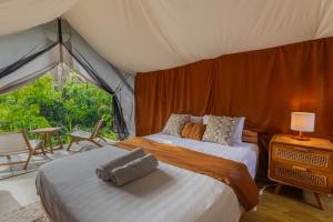 a bedroom with two beds in a tent at Camani Glamping in Karangasem