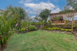 a garden in front of a house at Camani Glamping in Karangasem