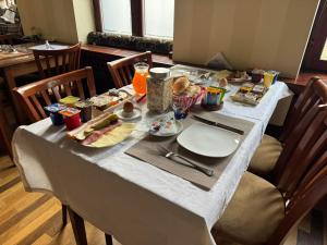 Ada Apartments في سراييفو: طاولة بيضاء عليها طعام ومشروبات