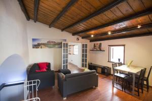 a living room with a couch and a table at Mulino in Cefalù