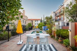 a patio with a table and chairs and a pool at Executive Apt - 2BR 1BA w Parking in Perth