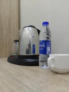 a bottle of water sitting next to a toaster at Soulmate Hotels & Suites in Lagos