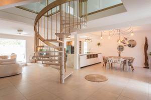 Saint-Paul的住宿－villa australina，客厅设有螺旋楼梯和桌子