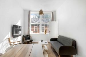 a living room with a couch and a table at Lovely Apartment At Solgaarden 9 Årsdale in Svaneke