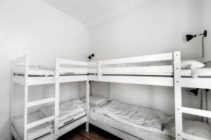 two white bunk beds in a room at Lovely Apartment At Beautiful Solgaarden 9 in Svaneke