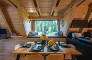 a room with a table and chairs in a tiny house at Chata Idylka in Pribylina