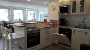 a kitchen with white cabinets and a stove top oven at Ferienwohnung Feuerbach in Telgte