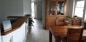 a dining room with a wooden table and chairs at Ferienwohnung Feuerbach in Telgte +12 photos