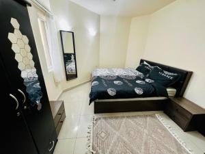 a small bedroom with a bed and a window at Dubai gate 1, JLT Q cluster in Dubai