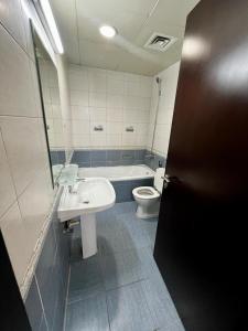 a bathroom with a sink and a toilet at Dubai gate 1, JLT Q cluster in Dubai